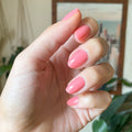 Papaya Gloss on customer hand